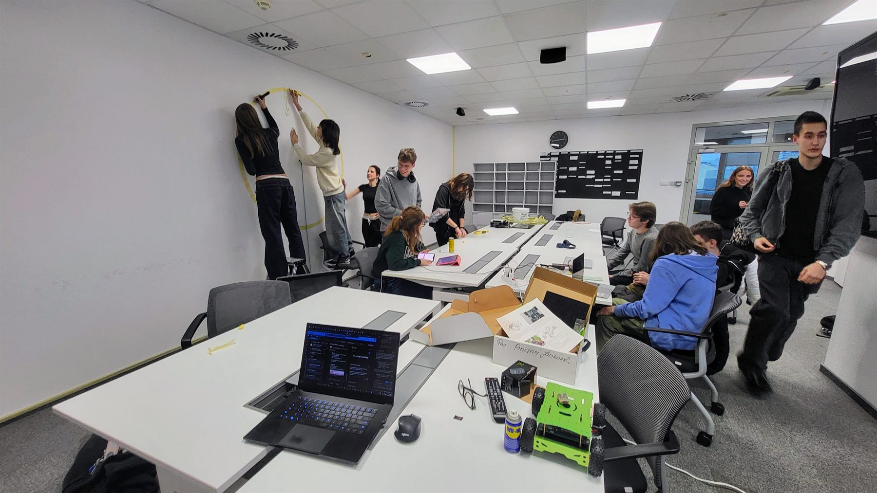 Students working together in the LALTech Lab classroom around laptops, tables, and prototyping materials.